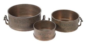 * Three brass Imperial grain measures Unsigned, circa 1825. The largest engraved KENT, Bushel