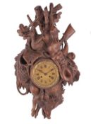 A Swiss ÔBlack ForestÕ carved linden wood cartel clock Unsigned, mid 19th century The eight-day