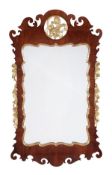 A walnut and parcel gilt wall mirror, circa 1750 and later, shaped rectangular plate, cartouche