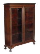 A mahogany and satinwood strung cabinet bookcase, circa 1890 and later, moulded frieze, a pair of