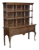 An oak dresser, second half 18th century, moulded cornice, carved multi panelled back, two open