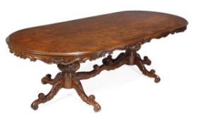 A carved hardwood, mahogany and burr walnut twin pedestal dining table, of recent manufacture,