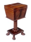 A George IV mahogany teapoy, circa 1825, sarcophagus shaped upper section, opening to a pierced