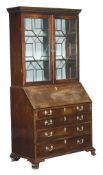 A George III mahogany bureau bookcase, circa 1770, dentil cornice, a pair of astragal glazed doors,