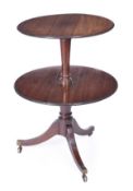 A George III mahogany two tier dumb waiter, circa 1780, each circular tier with moulded edge, each