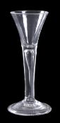 A plain-stemmed wine glass of drawn trumpet form, tear inclusion and a folded conical foot, 15.5cm