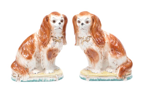 A pair of pottery models of King Charles spaniels of Bo`ness type, facing left and right and with