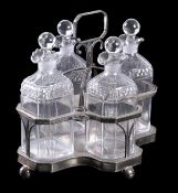 A silver-plate four division spirit decanter stand with decanters and ball stoppers, the stand 26cm