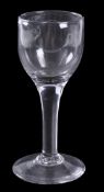 A plain-stemmed goblet, ovoid bowl, conical foot, 15.5cm high, mid 18th century. Provenance: The