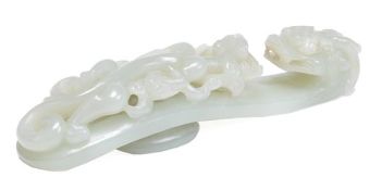 A Chinese pale celadon jade belt buckle, the hook in the form of a two horned dragon looking back