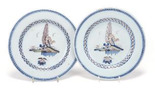 A pair of English delft polychrome chinoiserie plates, decorated with a house in a landscape, 23cm