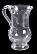 A glass baluster mug, applied with a loop handle, 14.5cm high, mid 18th century