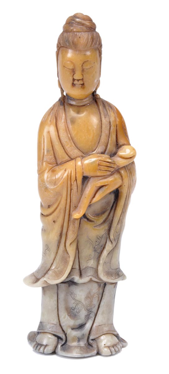 A Chinese soapstone figure of Guanyin, standing with hair piled high and wearing a loose robe