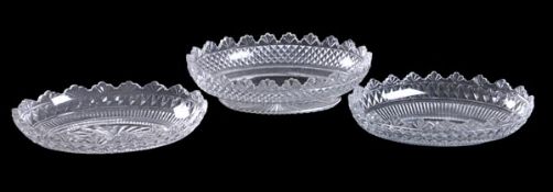 An oval cut-glass bowl, with fan-cut rim above a diamond band, 30cm long; and two others similar