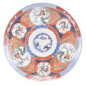 A Japanese Imari charger of circular dished form decorated in the centre with The Three Friends