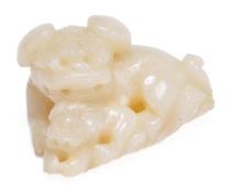 A Chinese white jade carving of a Buddhist lion with a cub at his feet, 4.9cm long, 18th-19th