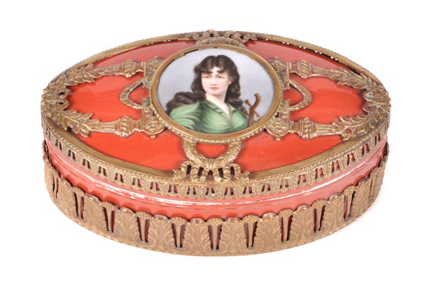 A Limoges porcelain gilt-metal-mounted iron-red ground oval box and cover, the cover mounted with a