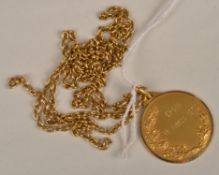 An Italian medal on longchain necklace, the medal engraved `Verona 18 Marzo 1972` on the front