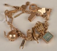 An entwined twin hoop bracelet, suspending several charm pendants including a serpent, a cat and a