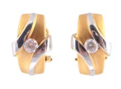 A pair of Italian diamond ear clips, each set with a brilliant cut diamond in a polished and