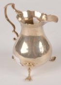 A George III silver baluster cream jug by Nathaniel Appleton & Ann Smith, London 1772, with a leaf