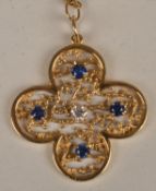 A sapphire and diamond pendant, the openwork four lobed lobed panel set with single round cut