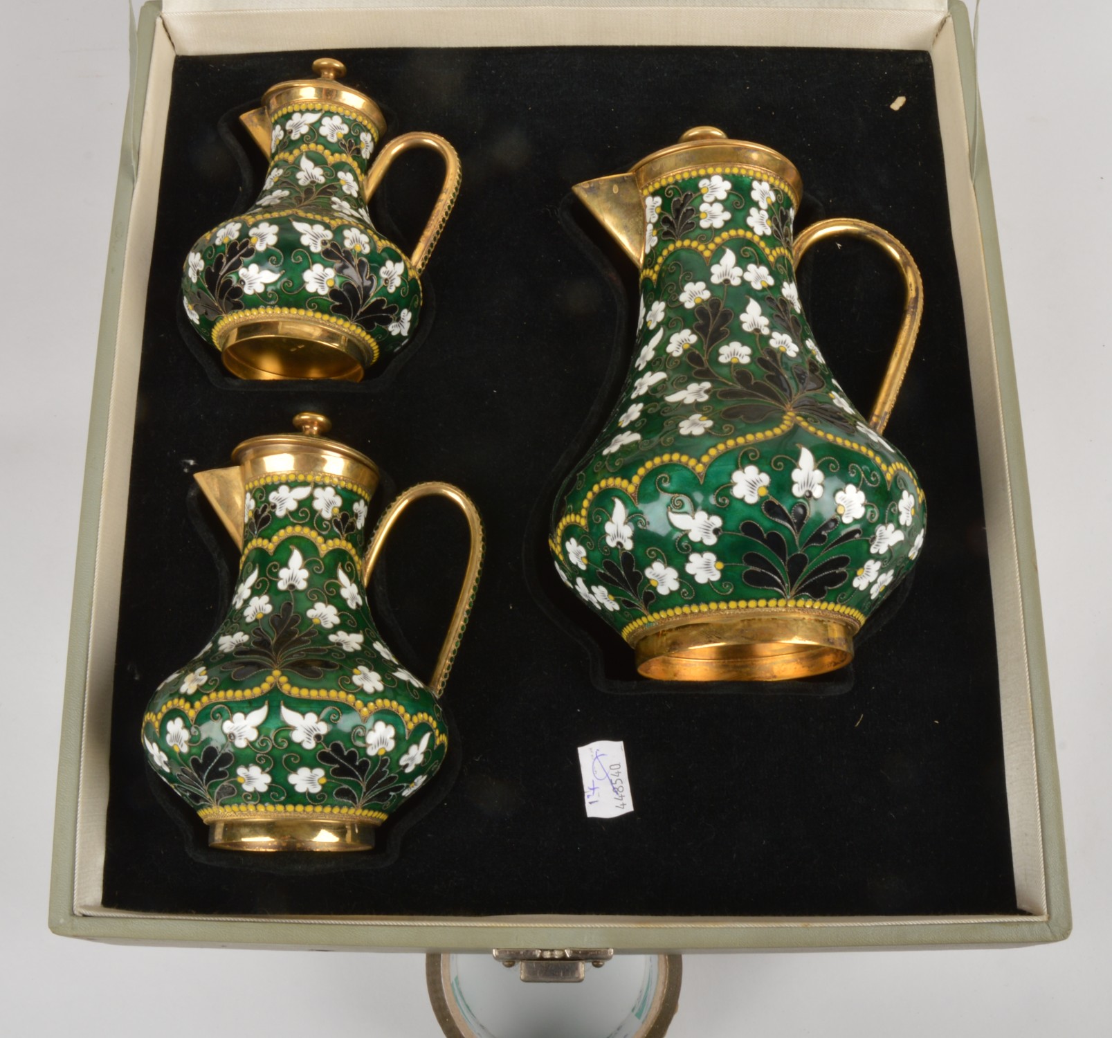 A graduated set of three Soviet Russian silver coloured gilt and enamel baluster jugs and covers,