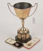 A silver two handled trophy cup by James Fenton & Co., Birmingham 1937, with upswept angualr