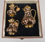 A graduated set of three Soviet Russian silver coloured gilt and enamel baluster jugs and covers,