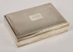 A silver rectangular cigarette box by Mappin & Webb Ltd., Birmingham 1921, the cover with engine