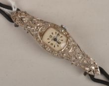 An Art Deco diamond set wristwatch, circa 1920, the cushion shape dial with Arabic and dagger