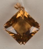 A citrine pendant, the square shape citrine set with double claws to each corner, to a `V` shape