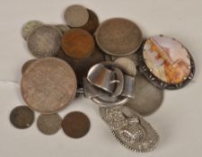 A small quantity of coins and three pieces of jewellery, including a carved cameo shell brooch,