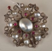 An Edwardian mother of pearl, diamond and ruby brooch pendant, of openwork circular cluster form