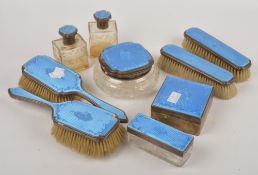 A matched blue enamel and silver mounted dressing table set, mostly by William Comyns & Sons Ltd.,