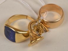 A lapis lazuli set signet ring, finger size P; a wide shank D shaped wedding ring stamped `E.A