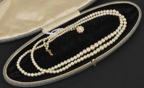 A two row graduated cultured pearl necklace, pearls measure 7 to 3 mm, diameter, on a 9ct gold and