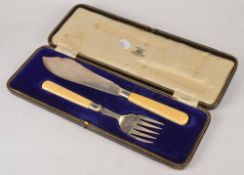 A pair of silver fish servers by John Sanderson, Sheffield 1911, with ivory handles, the knife 29cm