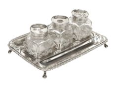 A George III silver oblong inkstand by Edward Aldridge, London 1771, with three glass cubes, two as