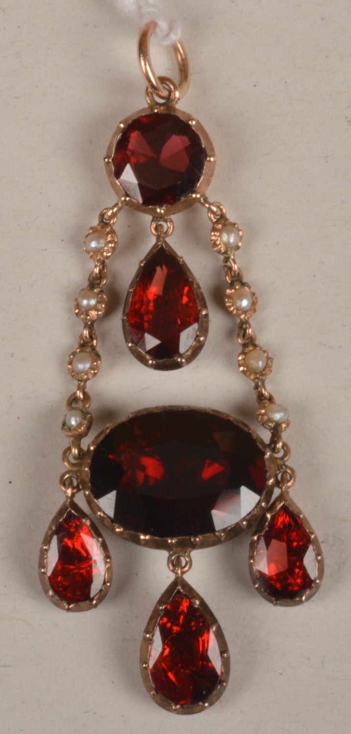 A Georgian garnet pendant, the triple pear shaped drops suspended from an oval garnet below a