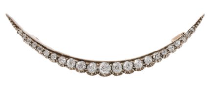 A late Victorian diamond crescent brooch, circa 1890, set along the length with twenty three old