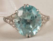 A blue zircon ring, the oval shape stone in a claw setting with diamond set shoulders, ring size J