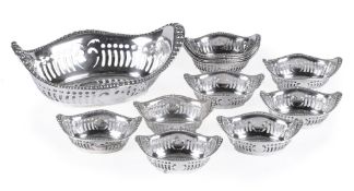 An American silver coloured suite of an oval basket and twelve smaller sweet baskets by Gorham