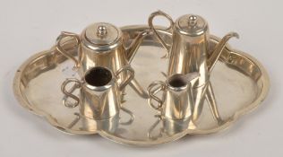 An Edwardian silver miniature four piece tea service and tray by J & J Maxfield Ltd., Sheffield