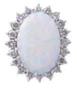 An opal and diamond cluster ring, the large oval opal cabochon claw set above a surround of twenty