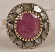 A Victorian ruby and diamond cluster ring, the oval faceted ruby with rose diamond border, with