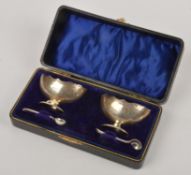 A pair of silver boat shaped salts by E J Houlston, Birmingham 1909, with shaped borders, engraved