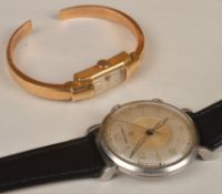 A lady`s hinged bangle wristwatch, the rectangular dial with arabic and baton markers, weight