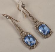 A pair of paste drop earrings, th scissor cut blue paste drops with a rounds cut white paste