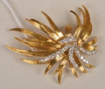 A diamond set stylised spray brooch, circa 1960 composed of five graduated rows of brilliant and
